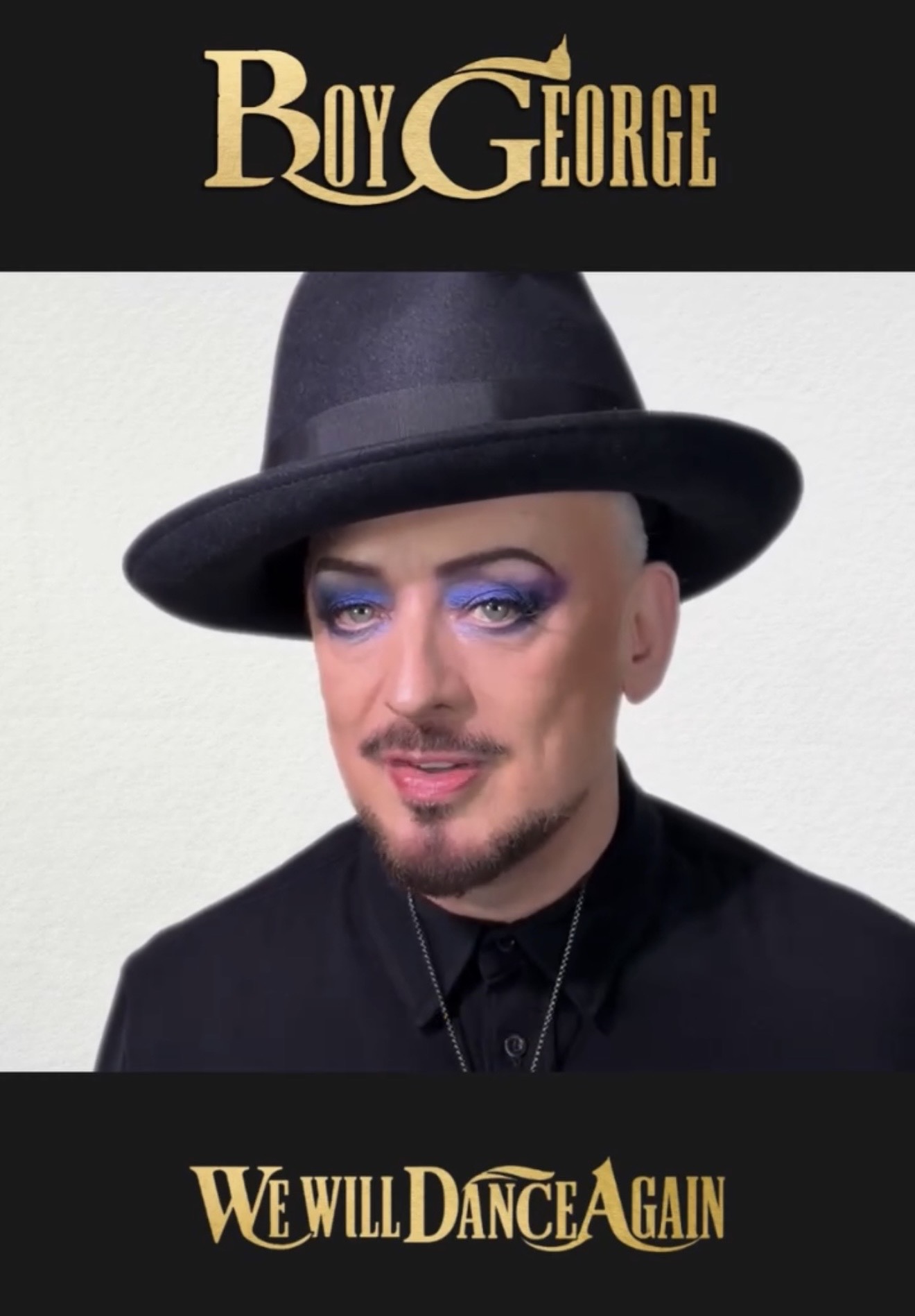 Boy George wearing a black hat and jacket, with the original gold Boy George and We Will Dance Again lettering